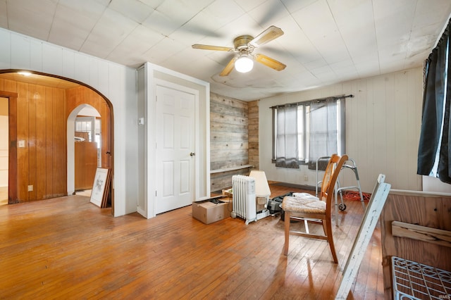 1614 E 24th St, Muncie, IN 47302 - office space with radiator, wooden walls, arched walkways, light wood-style flooring, and a ceiling fan