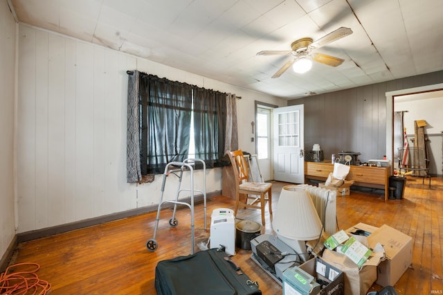 1614 E 24th St, Muncie, IN 47302 - interior space featuring wood-type flooring, ceiling fan, and wood walls