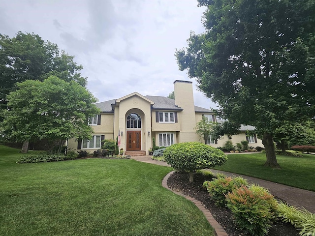 16 Johnson Pl, Evansville, IN 47714 - traditional-style home with a front yard, a chimney, and stucco siding