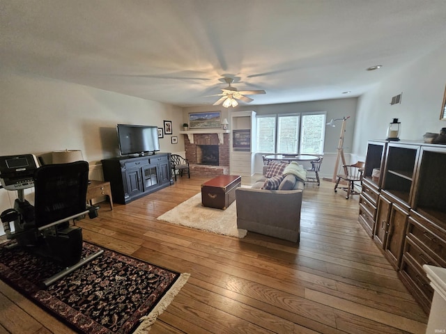 16 Johnson Pl, Evansville, IN 47714 - living area with ceiling fan, hardwood / wood-style floors, and a fireplace