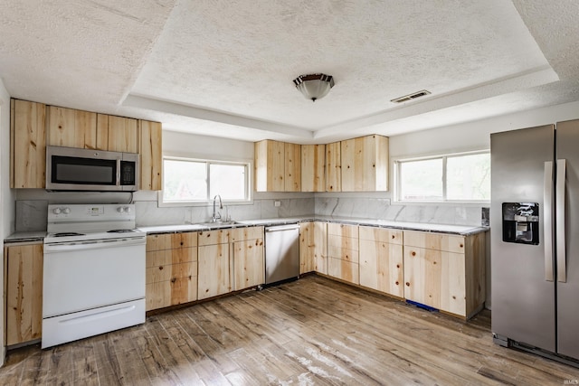 1000 N 500 E, Anderson, IN 46012 - kitchen with light brown cabinets, stainless steel appliances, a raised ceiling, a textured ceiling, and hardwood / wood-style flooring