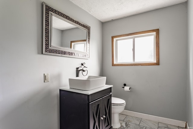 1000 N 500 E, Anderson, IN 46012 - bathroom featuring vanity, marble finish floors, and a textured ceiling