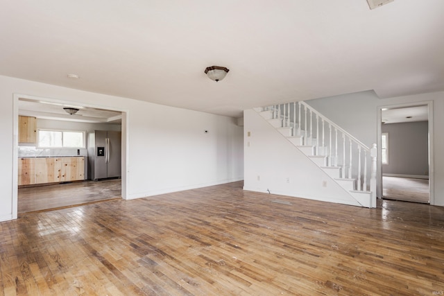 1000 N 500 E, Anderson, IN 46012 - unfurnished living room featuring hardwood / wood-style flooring and stairway