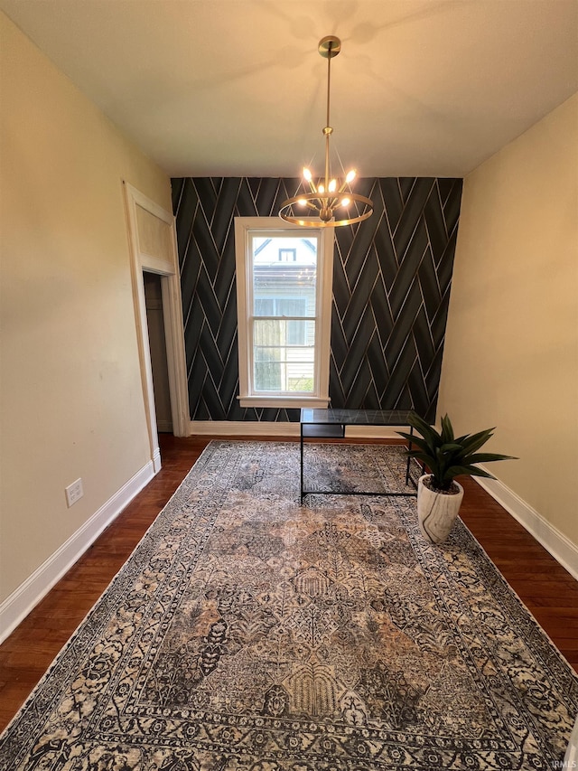 1906 N 15th St, Lafayette, IN 47904 - unfurnished dining area featuring a chandelier, dark wood-style flooring, and an accent wall