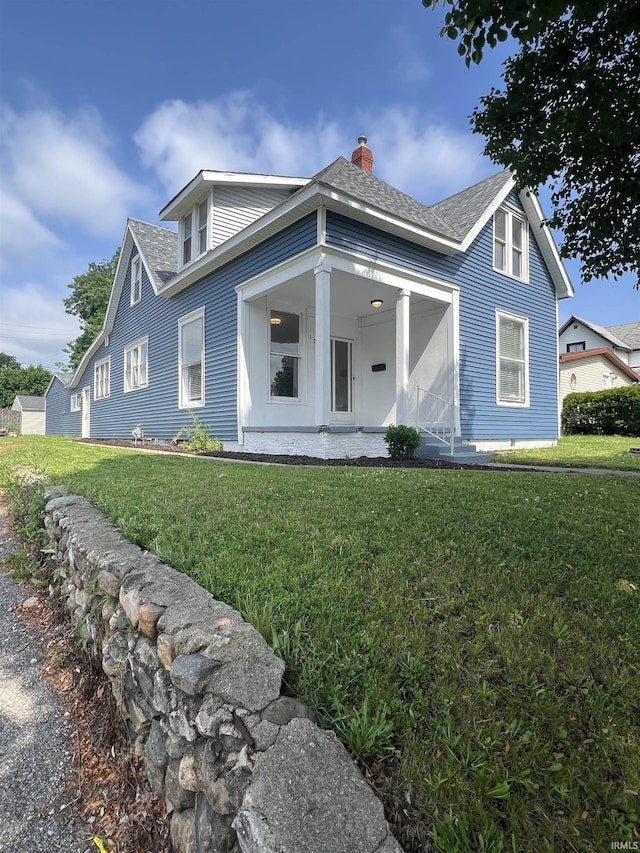 1906 N 15th St, Lafayette, IN 47904 - view of front of home with a chimney, a front yard, covered porch, and a shingled roof