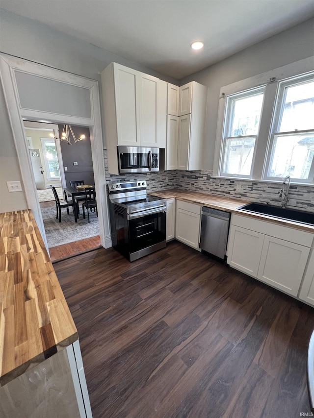 1906 N 15th St, Lafayette, IN 47904 - kitchen featuring appliances with stainless steel finishes, wood counters, white cabinets, dark wood-style flooring, and recessed lighting