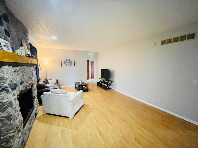 125 Shalley Dr, Plymouth, IN 46563 - living area with light wood-style floors and a stone fireplace