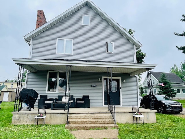 125 Shalley Dr, Plymouth, IN 46563 - view of front facade featuring a porch, a chimney, and a front lawn