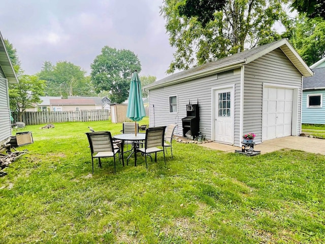 125 Shalley Dr, Plymouth, IN 46563 - view of yard featuring an outdoor structure, concrete driveway, a detached garage, and outdoor dining area