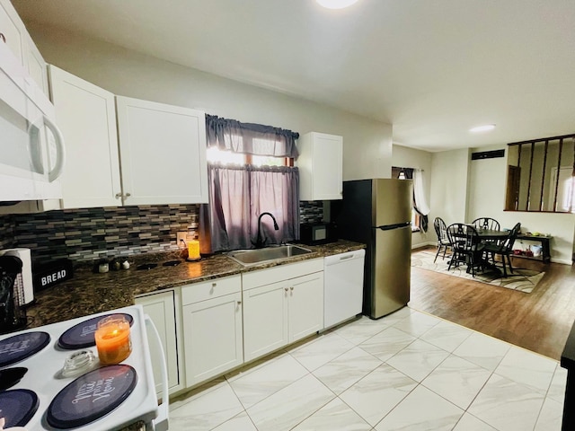 125 Shalley Dr, Plymouth, IN 46563 - kitchen with white appliances, backsplash, white cabinetry, and dark stone counters
