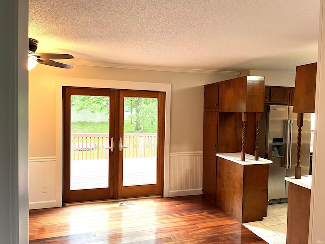 758 W 400 S Rd, Wabash, IN 46992 - kitchen featuring stainless steel fridge, light wood-style flooring, light countertops, a textured ceiling, and wainscoting