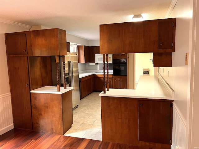758 W 400 S Rd, Wabash, IN 46992 - kitchen featuring oven, white microwave, a peninsula, stainless steel refrigerator with ice dispenser, and light countertops