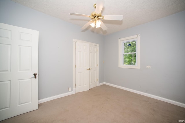 631 W 8th St, Bicknell, IN 47512 - unfurnished bedroom with light carpet, a textured ceiling, a closet, and ceiling fan