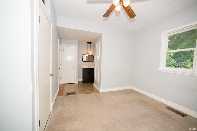631 W 8th St, Bicknell, IN 47512 - unfurnished bedroom featuring carpet flooring, connected bathroom, and ceiling fan