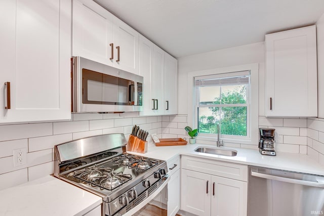 516 W Navarre St, South Bend, IN 46616 - kitchen with appliances with stainless steel finishes, light countertops, white cabinetry, and backsplash