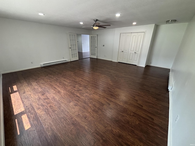 1821 E Johnson Ln, Vincennes, IN 47591 - empty room featuring a baseboard radiator, a ceiling fan, recessed lighting, dark wood-type flooring, and french doors
