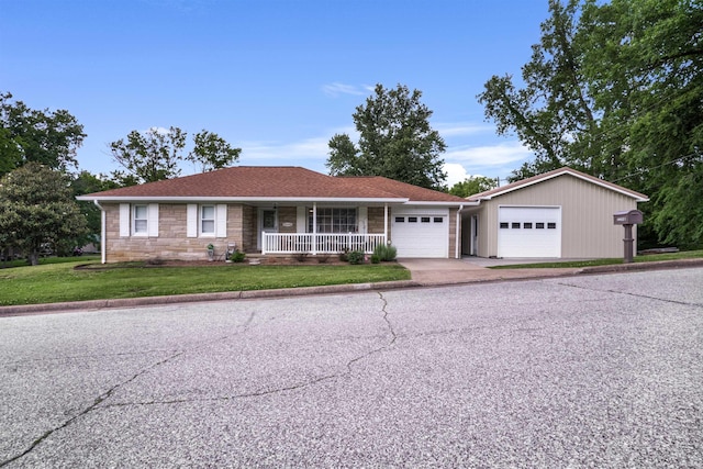 2208 Franklin St, Tell City, IN 47586 - ranch-style house with a porch, a garage, a front yard, driveway, and stone siding