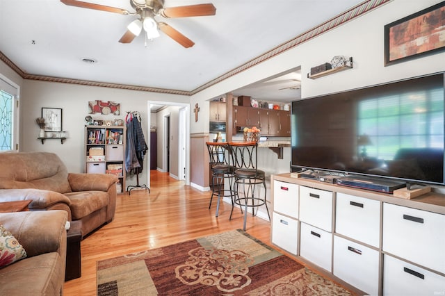 2208 Franklin St, Tell City, IN 47586 - living area with ceiling fan, light wood finished floors, and ornamental molding