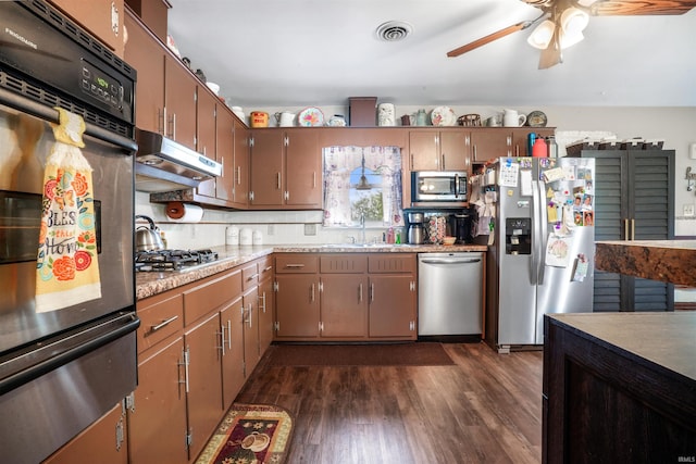2208 Franklin St, Tell City, IN 47586 - kitchen with appliances with stainless steel finishes, a ceiling fan, dark wood-style floors, under cabinet range hood, and light countertops