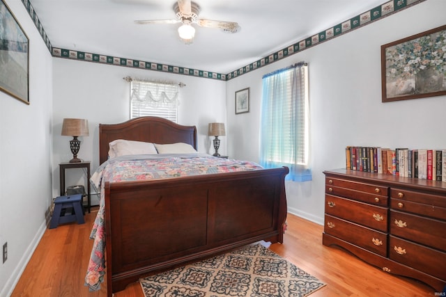 2208 Franklin St, Tell City, IN 47586 - bedroom with light wood finished floors, a baseboard radiator, and a ceiling fan