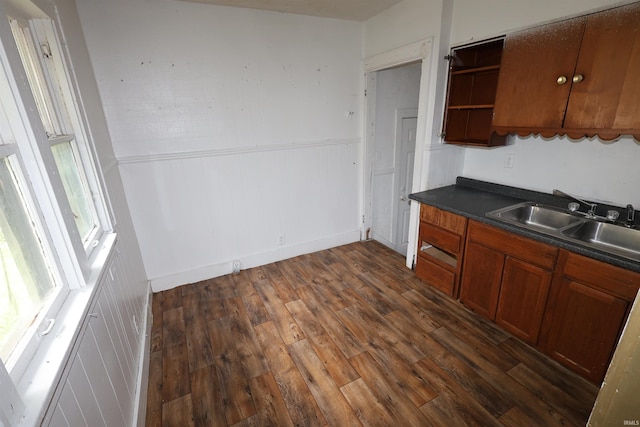 901 Lawndale Ave, South Bend, IN 46628 - kitchen featuring dark wood finished floors, dark countertops, open shelves, brown cabinetry, and a wainscoted wall