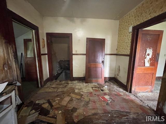 758 N Olive St, South Bend, IN 46628 - spare room featuring baseboards and wallpapered walls
