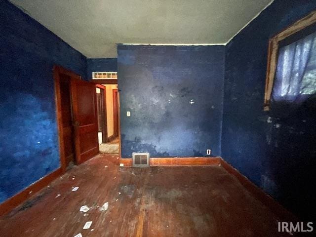 758 N Olive St, South Bend, IN 46628 - spare room featuring wood-type flooring and baseboards
