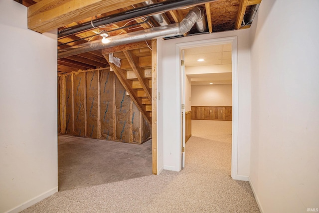 13920 Lexington Cir, Granger, IN 46530 - unfinished basement with carpet flooring, stairs, and wooden walls