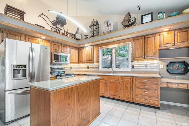 17991 Sable Ridge Dr, South Bend, IN 46635 - kitchen with appliances with stainless steel finishes, backsplash, brown cabinetry, and light tile patterned flooring