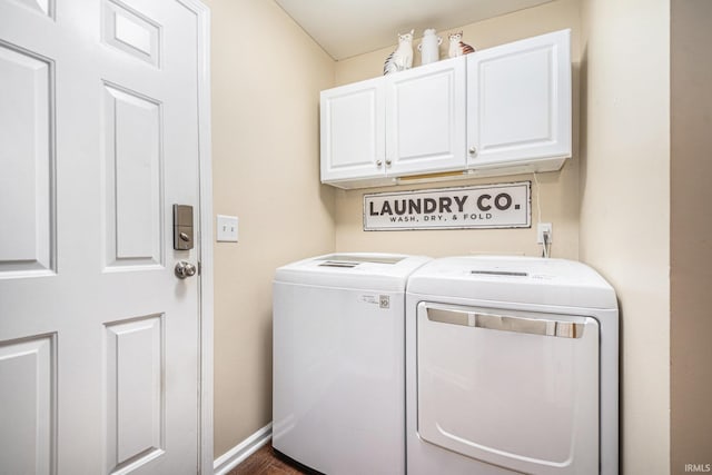 17991 Sable Ridge Dr, South Bend, IN 46635 - laundry area with cabinet space, washer and clothes dryer, and dark wood finished floors
