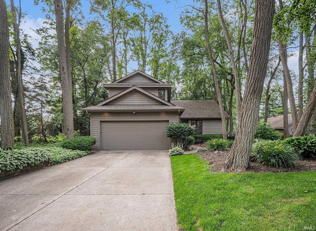 17991 Sable Ridge Dr, South Bend, IN 46635 - view of front of home featuring concrete driveway, roof with shingles, a front yard, and a garage