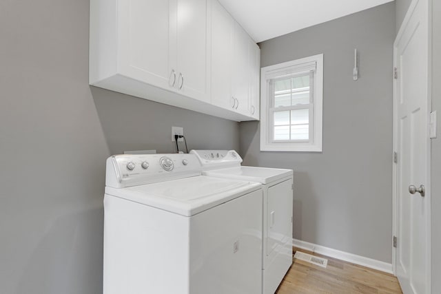 2405 E State Blvd, Fort Wayne, IN 46805 - laundry area with independent washer and dryer, cabinet space, and light wood finished floors