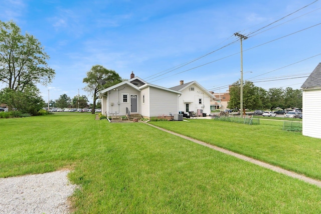 2405 E State Blvd, Fort Wayne, IN 46805 - back of property featuring entry steps, a yard, and a chimney