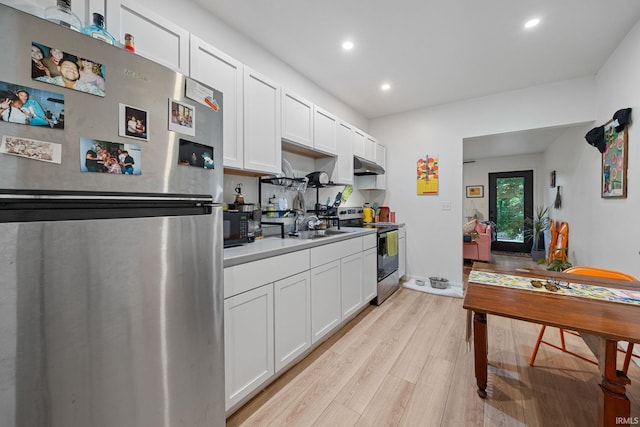 622 Romig St, Lafayette, IN 47901 - kitchen with stainless steel appliances, light wood-type flooring, recessed lighting, under cabinet range hood, and white cabinets