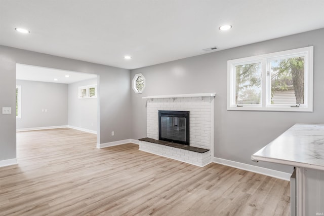 3524 Contessa Dr, Fort Wayne, IN 46816 - unfurnished living room featuring light wood-type flooring, recessed lighting, and a brick fireplace