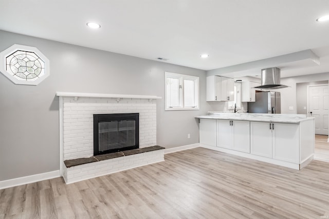 3524 Contessa Dr, Fort Wayne, IN 46816 - unfurnished living room featuring light wood-style floors, recessed lighting, and a fireplace