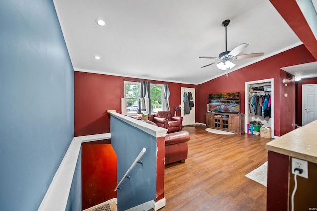 901 N Timberline Cir E, Warsaw, IN 46582 - living area with light wood finished floors, crown molding, ceiling fan, lofted ceiling, and recessed lighting