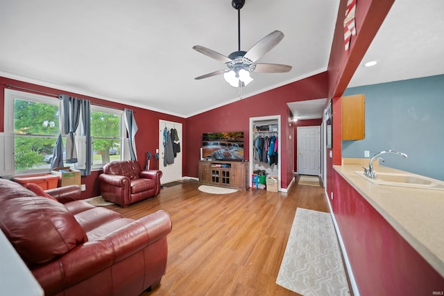 901 N Timberline Cir E, Warsaw, IN 46582 - living room with light wood-style flooring, crown molding, vaulted ceiling, and a ceiling fan