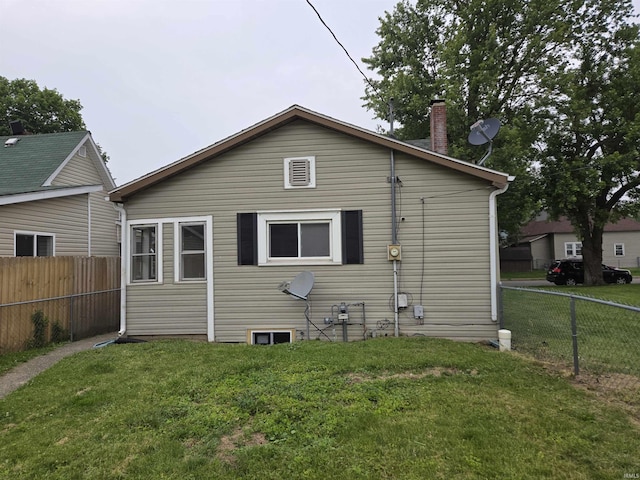 107 W S B St, Gas City, IN 46933 - rear view of property with a fenced backyard and a chimney
