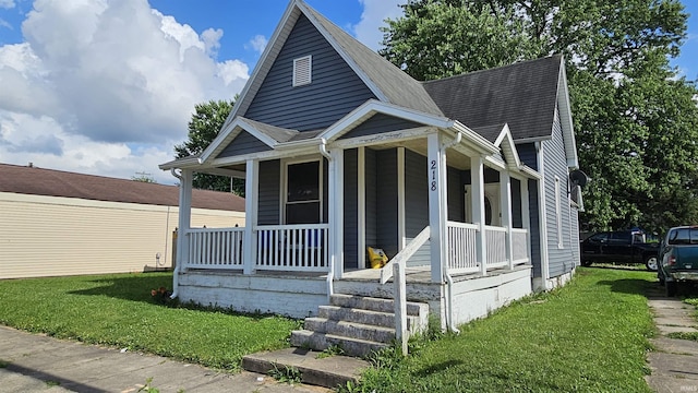 218 W Main St, Farmersburg, IN 47850 - view of front of home featuring covered porch, a front yard, and roof with shingles