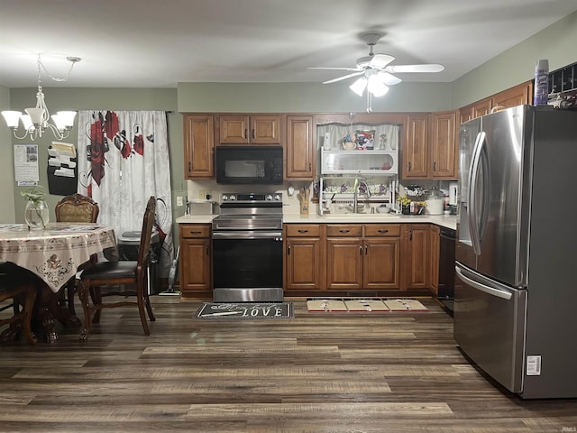 840 Giesler Rd, Jasper, IN 47546 - kitchen featuring stainless steel appliances, light countertops, a chandelier, brown cabinetry, and dark wood-style floors