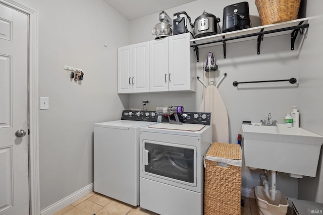 233 Sinclair Dr, West Lafayette, IN 47906 - laundry room with cabinet space, independent washer and dryer, and light tile patterned floors