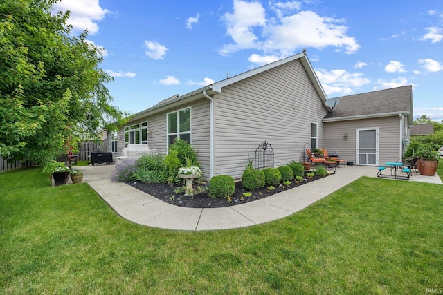 233 Sinclair Dr, West Lafayette, IN 47906 - view of side of home featuring a patio and a lawn