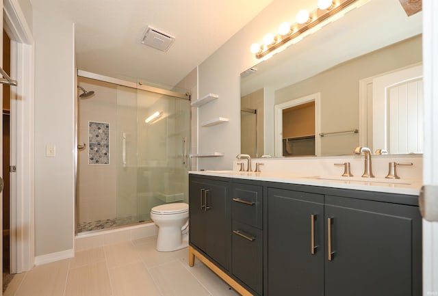 2410 Trillium Cv, Huntertown, IN 46748 - bathroom featuring a stall shower, double vanity, a walk in closet, and tile patterned flooring