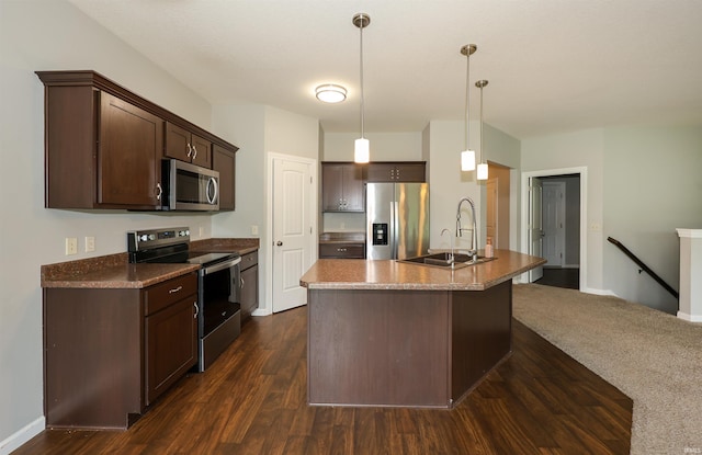 2410 Trillium Cv, Huntertown, IN 46748 - kitchen with stainless steel appliances, dark brown cabinetry, dark wood-style flooring, pendant lighting, and an island with sink