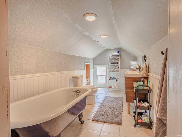 3020 Parnell Ave, Fort Wayne, IN 46805 - full bath with wainscoting, a freestanding bath, lofted ceiling, vanity, and tile patterned flooring