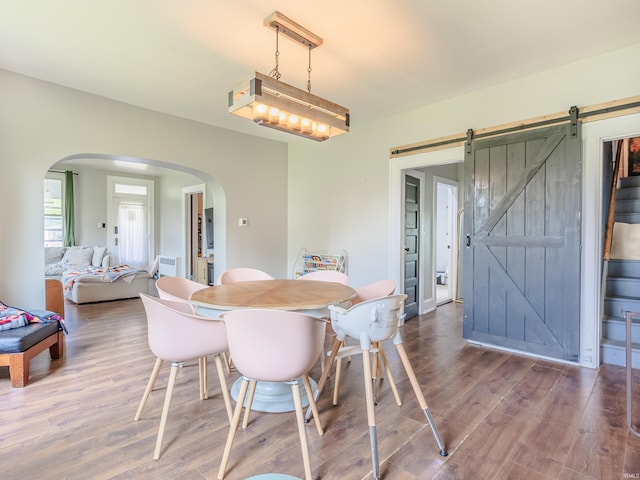 3020 Parnell Ave, Fort Wayne, IN 46805 - dining area with a barn door, arched walkways, and wood finished floors