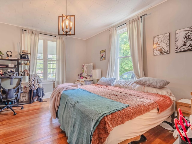 3020 Parnell Ave, Fort Wayne, IN 46805 - bedroom featuring multiple windows, a chandelier, and light wood-style flooring