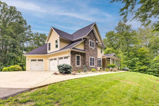 5007 W Michael Ln, Bloomington, IN 47404 - view of property exterior featuring stone siding, concrete driveway, a yard, roof with shingles, and an attached garage
