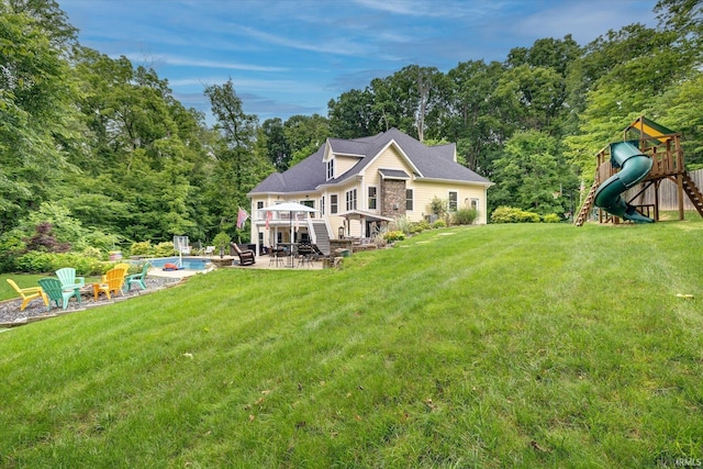 5007 W Michael Ln, Bloomington, IN 47404 - rear view of property featuring an outdoor fire pit, a playground, a wooden deck, a yard, and a patio